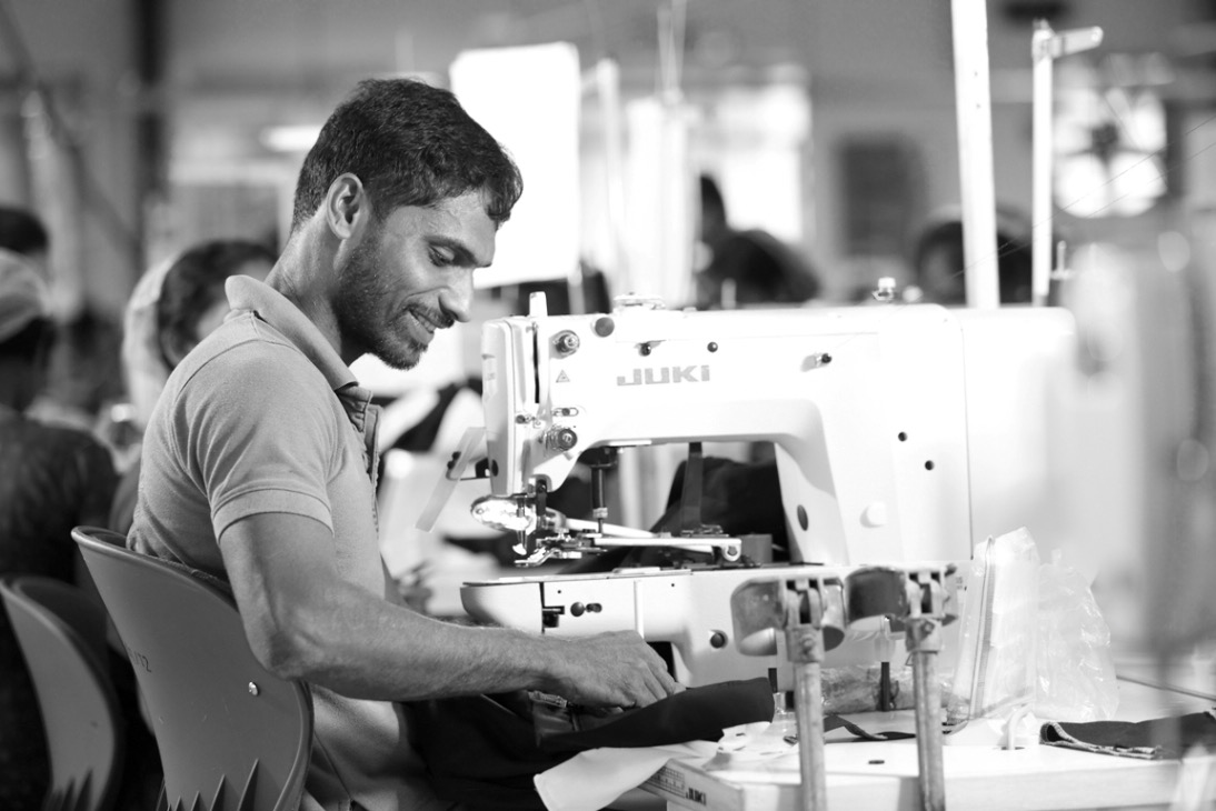 Man is working on sewing machine